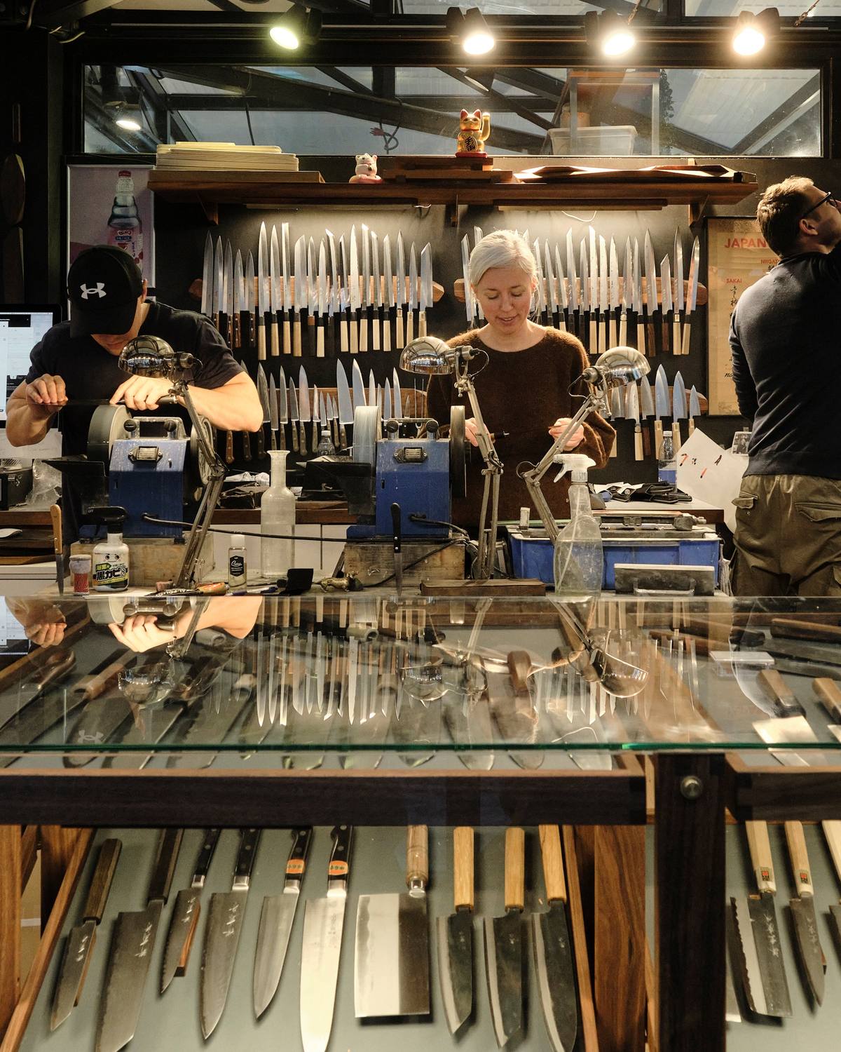 The sharpening station at Foodgear's shop in Copenhagen, with the knife wall behind and the display counter in front